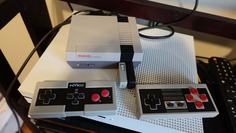 Notice the extra two buttons on the 8Bitdo controller (right) and the smaller control pad on the Miniboss (left).